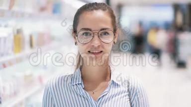 <strong>化妆品店</strong>女孩眼镜的肖像微笑，看镜头，慢动作